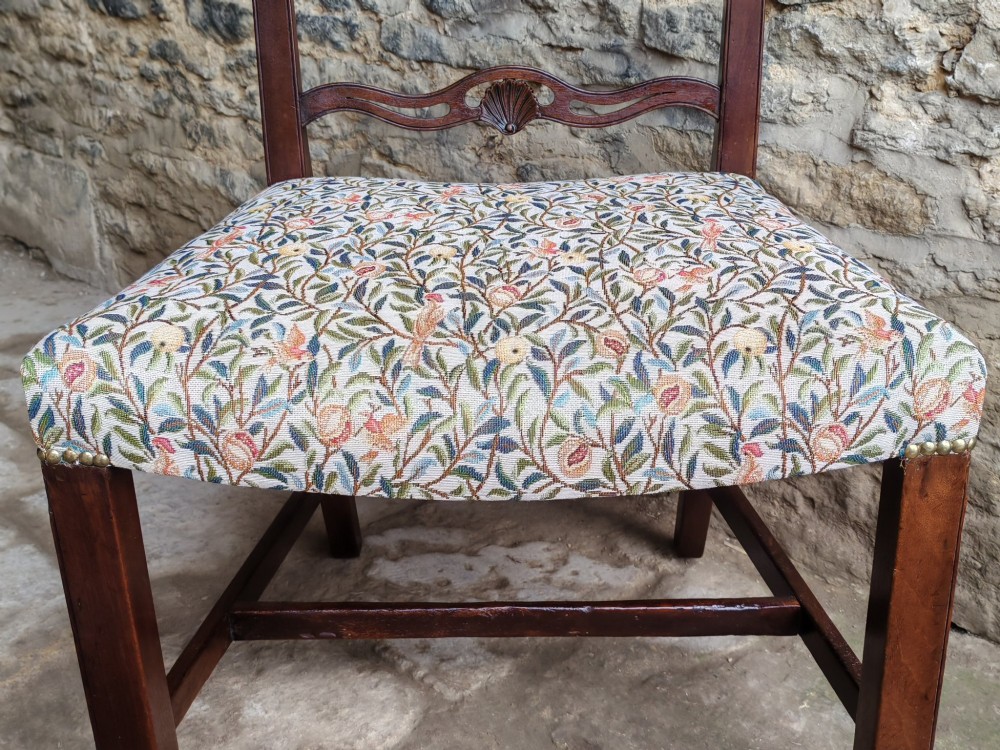A Victorian mahogany ladderback side chair featuring four carved shell motifs on the back rails and a floral tapestry drop-in seat. View VII