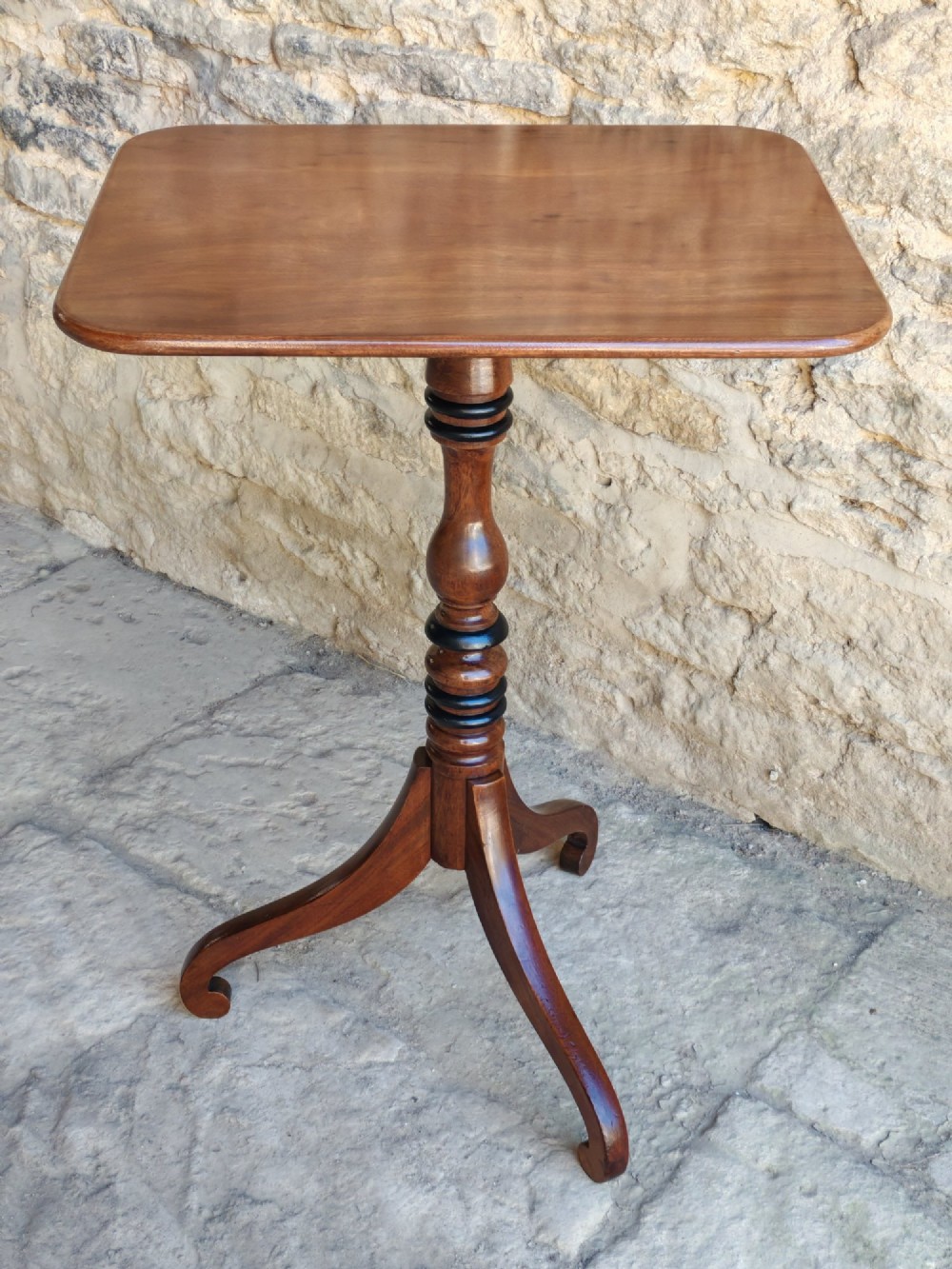 A Regency yew wood tripod table featuring a rectangular top with rounded corners, a turned central column with ebonised rings, and three splayed legs. View II