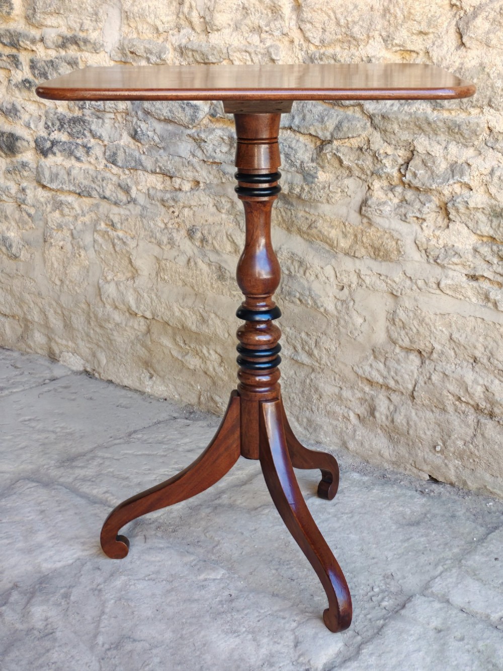 A Regency yew wood tripod table featuring a rectangular top with rounded corners, a turned central column with ebonised rings, and three splayed legs. View III