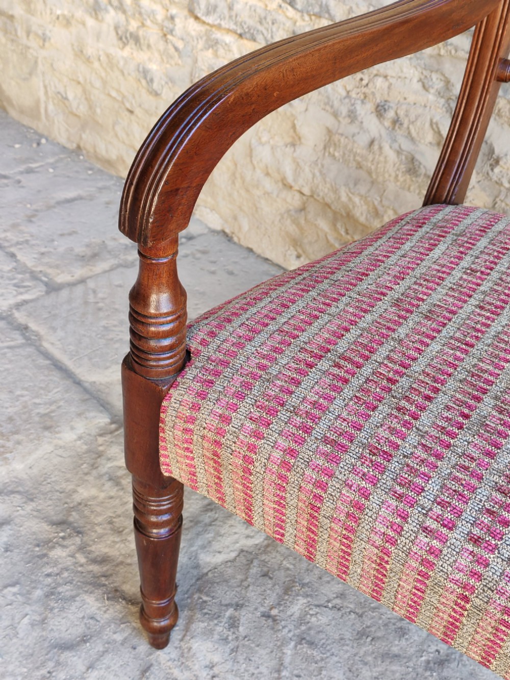 A Regency dark mahogany carver chair featuring a carved rope twist back rail, curved armrests, turned front legs, and a patterned woven upholstery seat. View VII