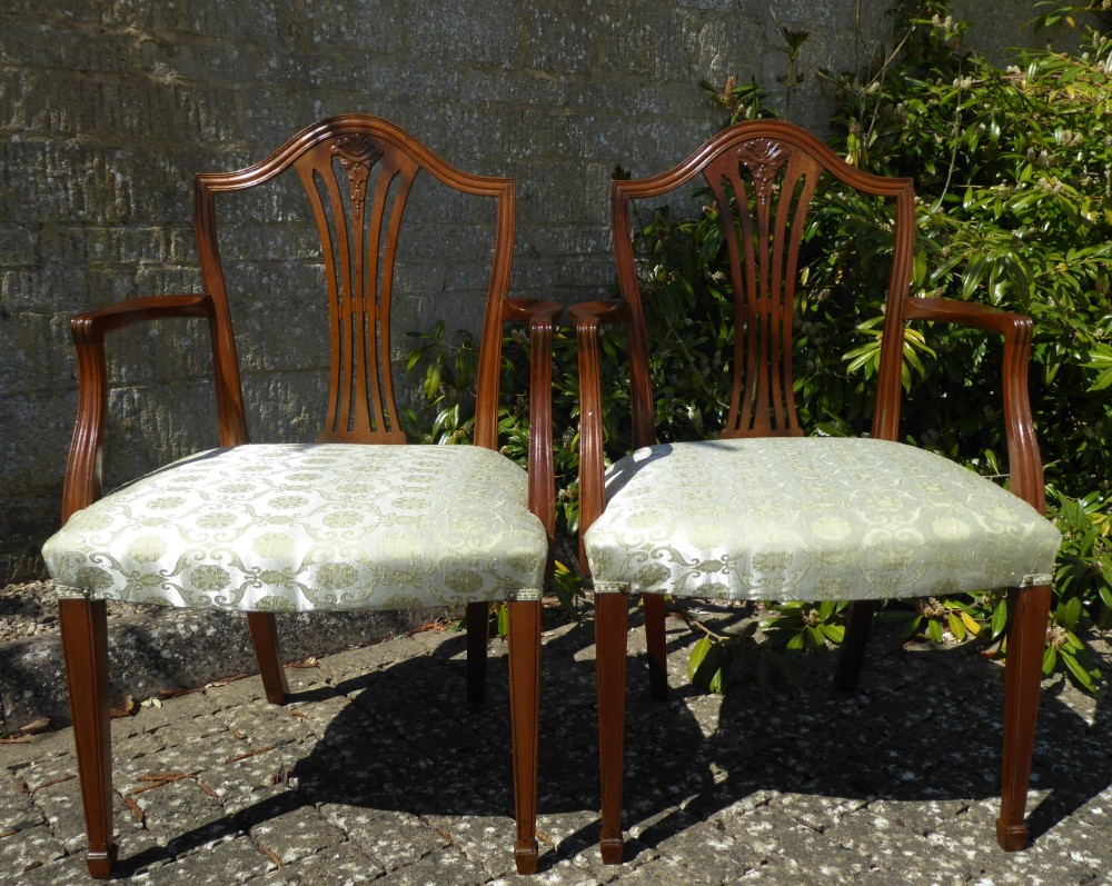 A set of six mahogany dining chairs featuring carved pierced back splats, tapered legs, and pale green patterned upholstery. View II
