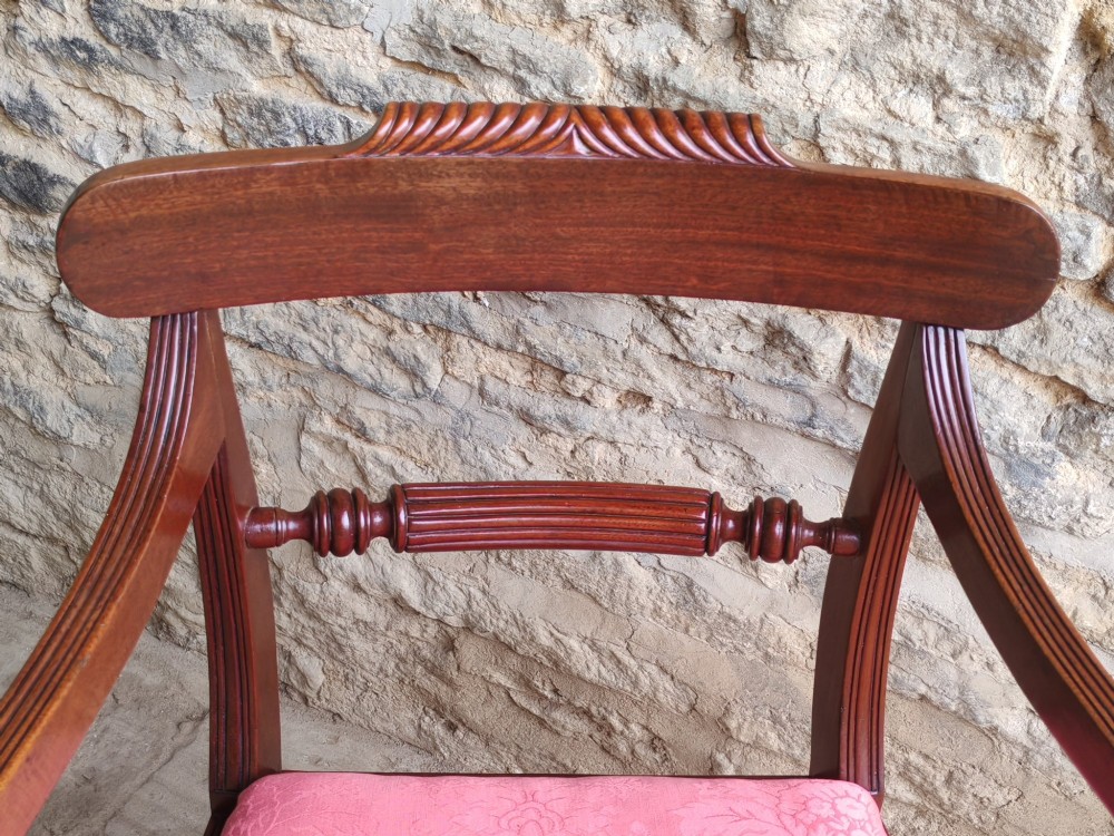 A Regency mahogany carver chair featuring scrolled arms, rope twist carving on the back rail, and a pink upholstered seat. View V