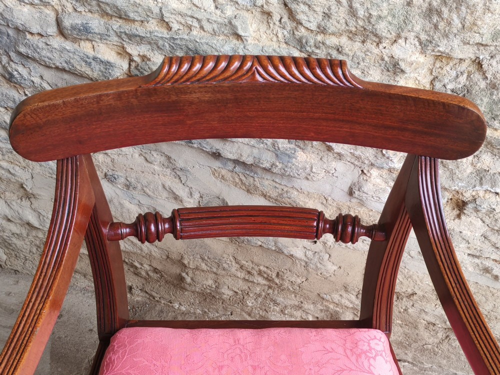 A Regency mahogany carver chair featuring scrolled arms, rope twist carving on the back rail, and a pink upholstered seat. View VI