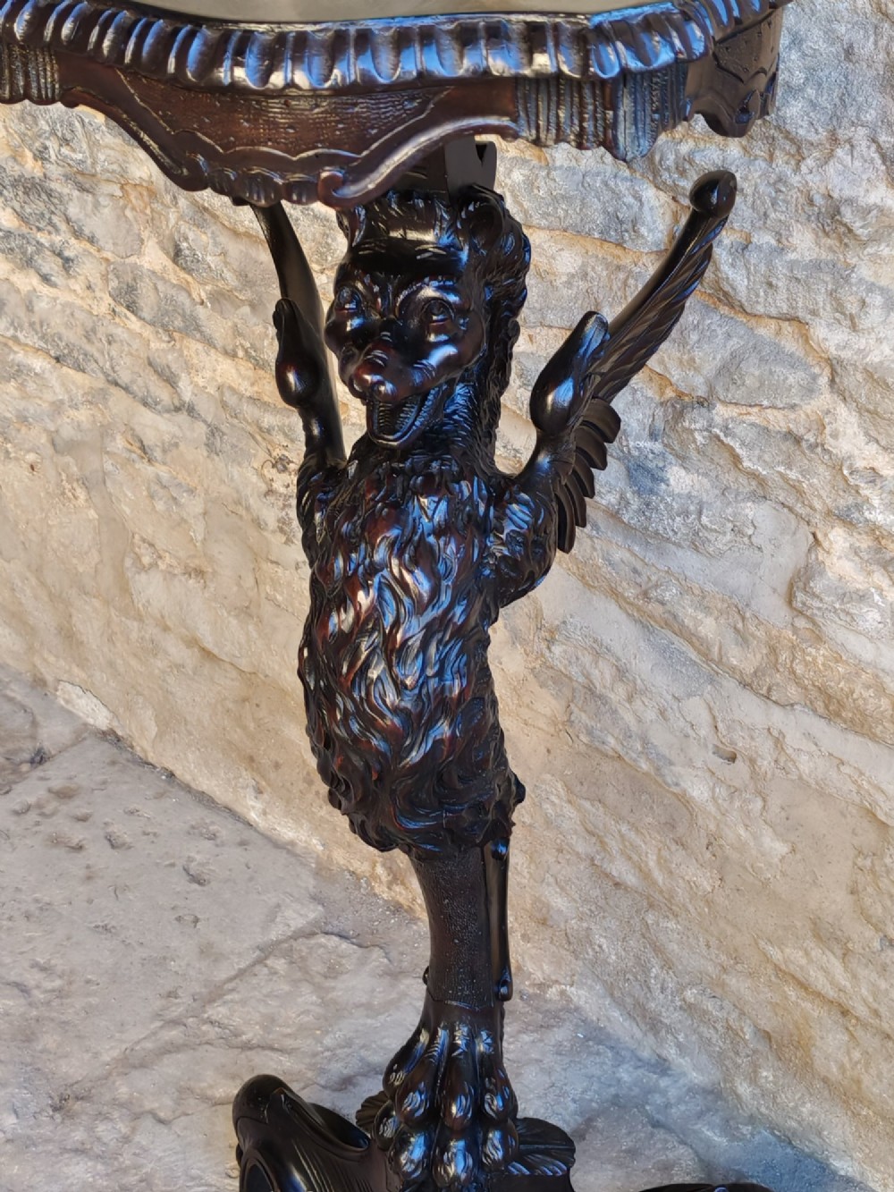 A nineteenth-century dark wood torchere stand featuring a hand-carved dragon support column and a molded circular top on a tripod base. View II