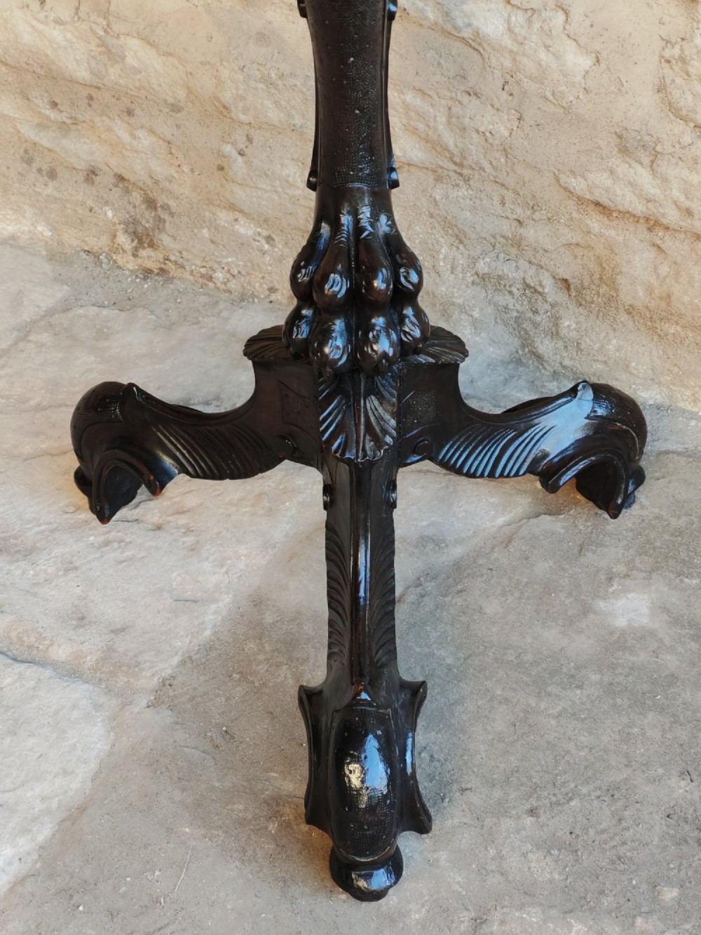 A nineteenth-century dark wood torchere stand featuring a hand-carved dragon support column and a molded circular top on a tripod base. View V