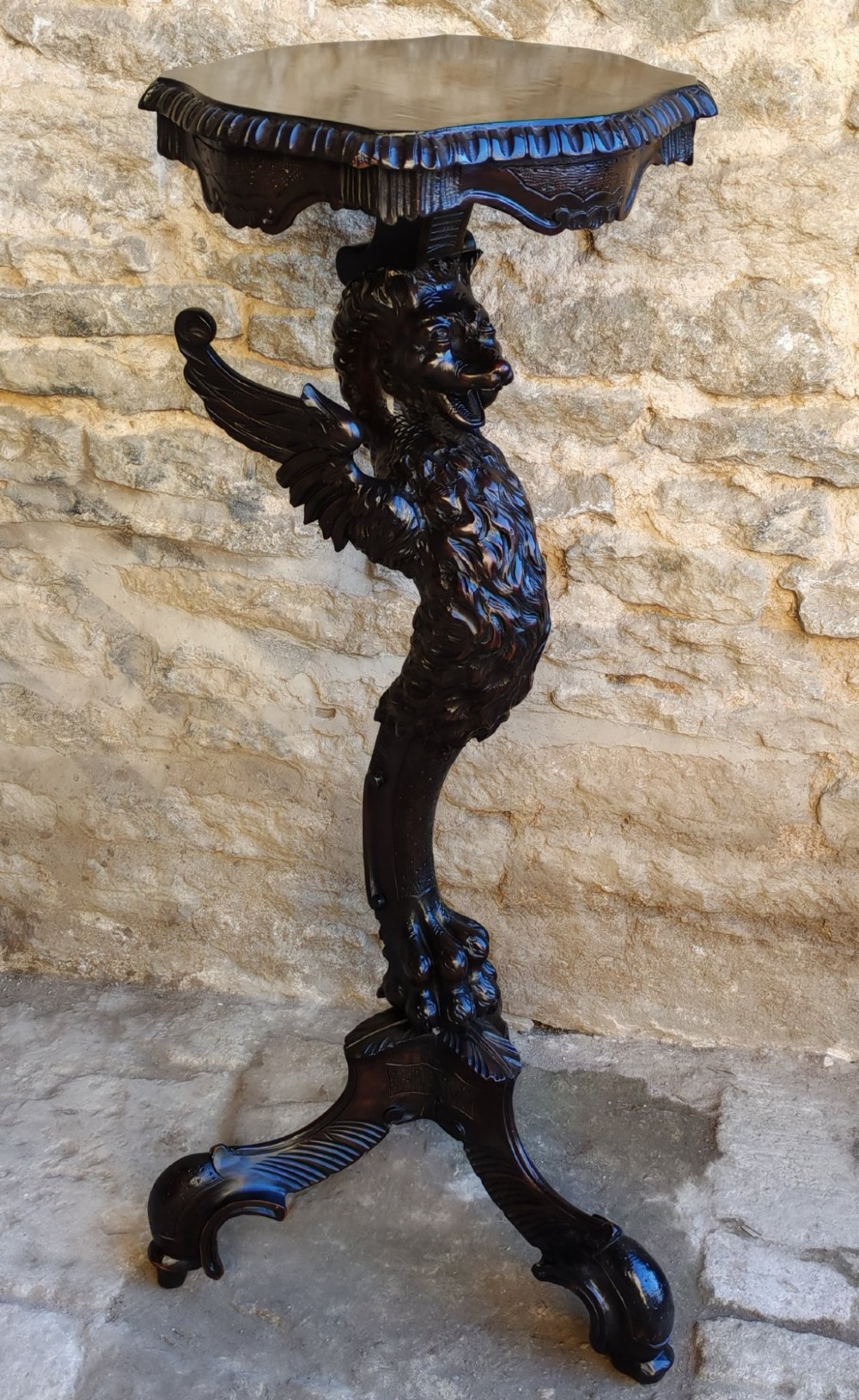A nineteenth-century dark wood torchere stand featuring a hand-carved dragon support column and a molded circular top on a tripod base. View VI