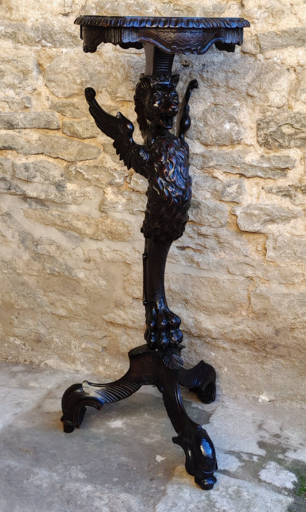 A nineteenth-century dark wood torchere stand featuring a hand-carved dragon support column and a molded circular top on a tripod base. View VIII
