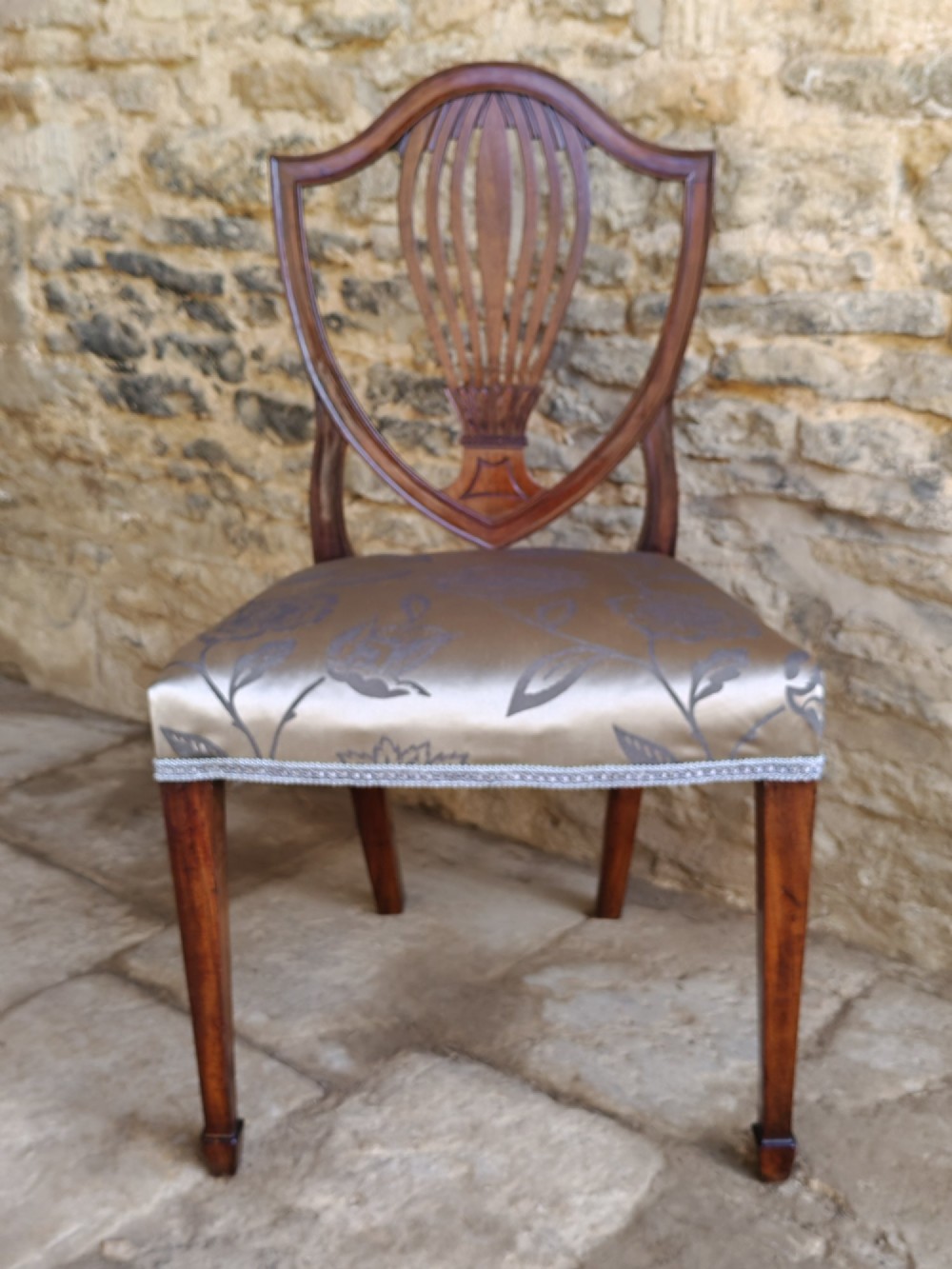 Set of four antique mahogany Hepplewhite dining chairs with carved shield backs and pattern upholstered seats. View III