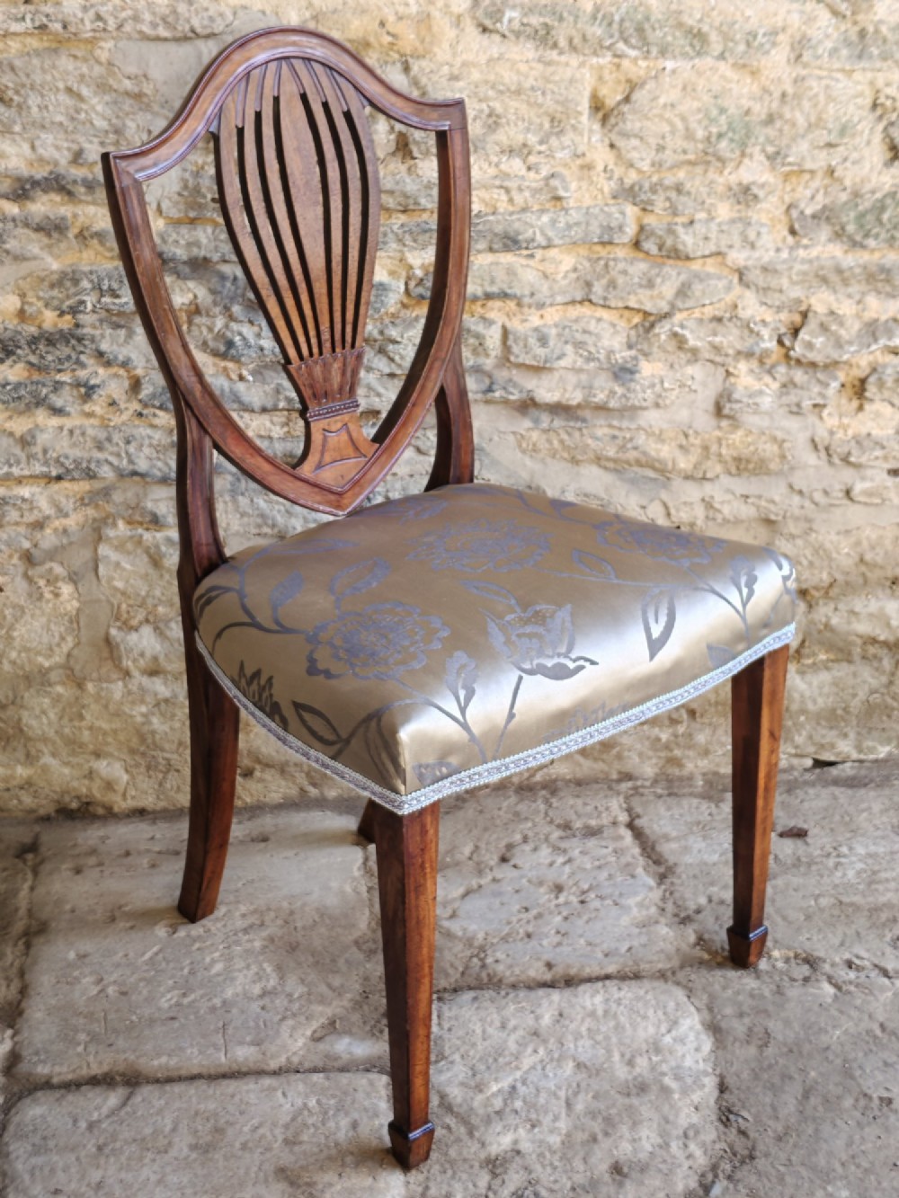 Set of four antique mahogany Hepplewhite dining chairs with carved shield backs and pattern upholstered seats. View IV