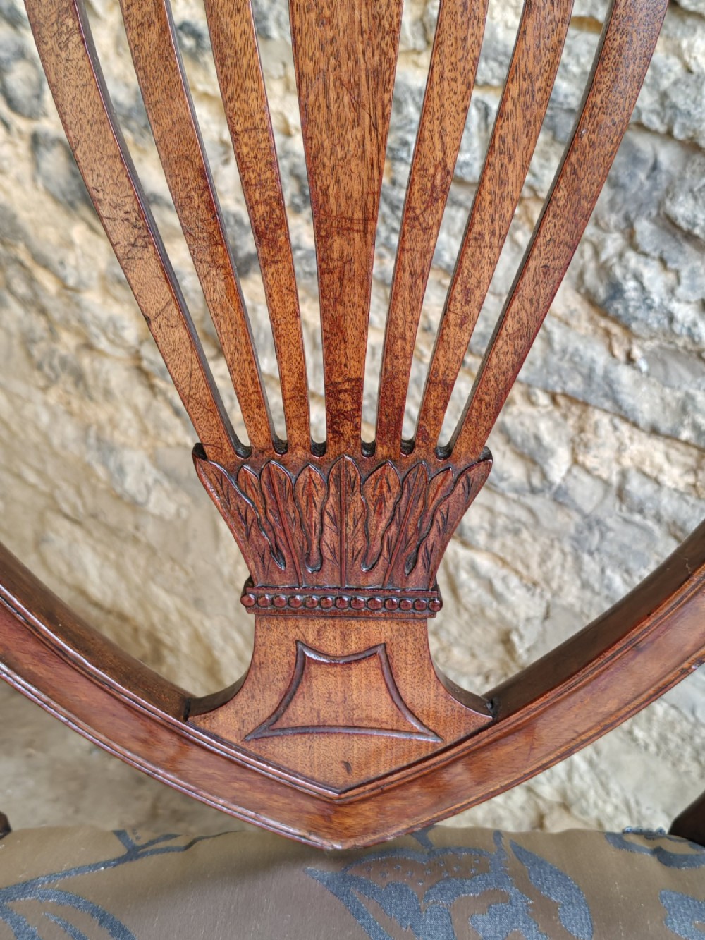 Set of four antique mahogany Hepplewhite dining chairs with carved shield backs and pattern upholstered seats. View VI