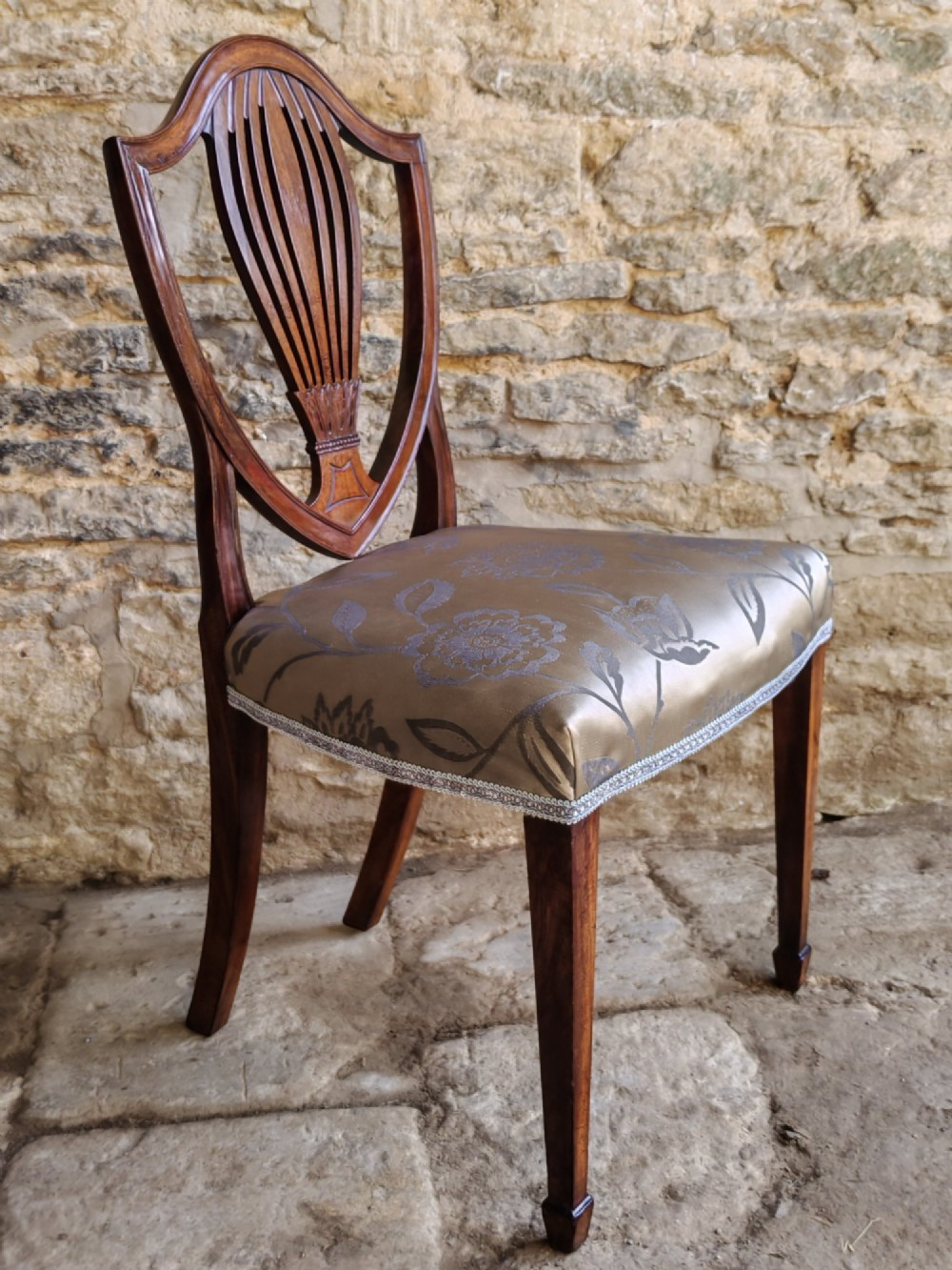 Set of four antique mahogany Hepplewhite dining chairs with carved shield backs and pattern upholstered seats. View VIII