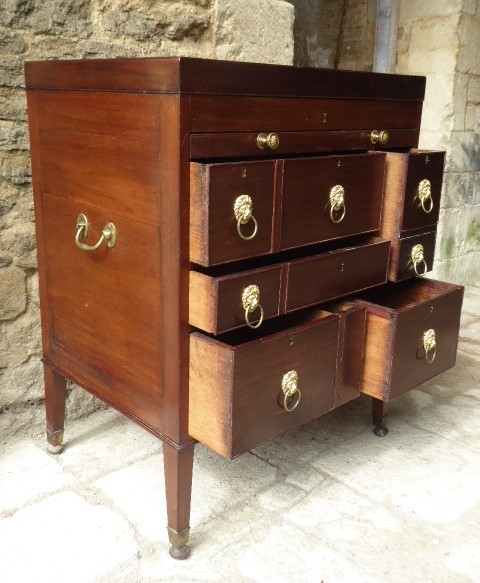 An eighteenth-century mahogany campaign chest with an open top lid, side brass handles, and an extended writing slope lined with green baize. View III