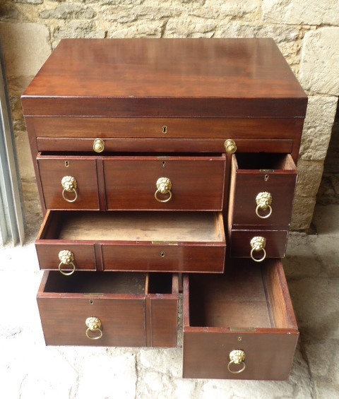 An eighteenth-century mahogany campaign chest with an open top lid, side brass handles, and an extended writing slope lined with green baize. View IV