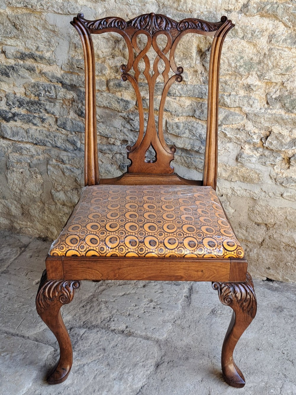 A 19th-century walnut side chair featuring an intricately carved pierced back splat, cabriole legs with carved knees, and a patterned upholstered seat. View III