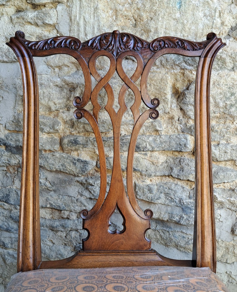 A 19th-century walnut side chair featuring an intricately carved pierced back splat, cabriole legs with carved knees, and a patterned upholstered seat. View IV