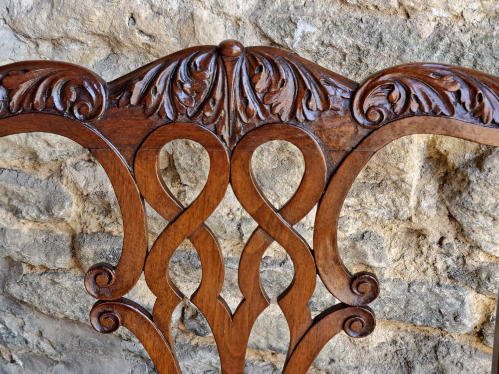 A 19th-century walnut side chair featuring an intricately carved pierced back splat, cabriole legs with carved knees, and a patterned upholstered seat. View V