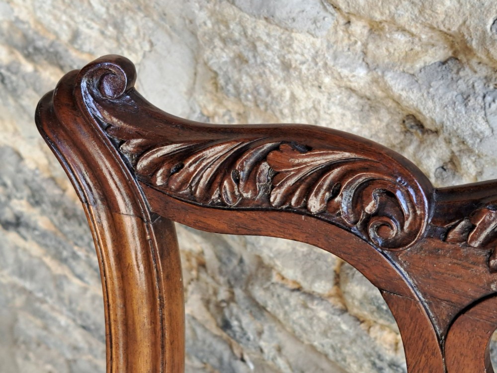 A 19th-century walnut side chair featuring an intricately carved pierced back splat, cabriole legs with carved knees, and a patterned upholstered seat. View VII