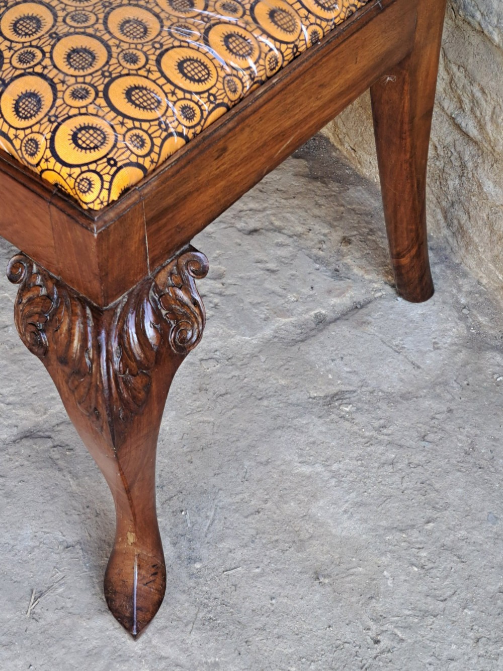 A 19th-century walnut side chair featuring an intricately carved pierced back splat, cabriole legs with carved knees, and a patterned upholstered seat. View VIII
