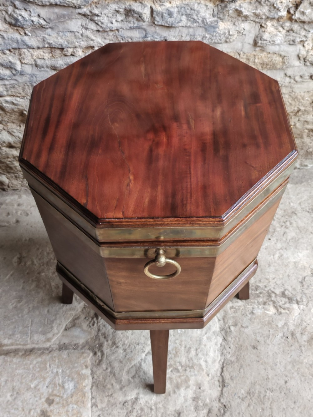 An 18th-century octagonal mahogany wine cooler with brass bindings, brass handles, and four tapered square legs. View III