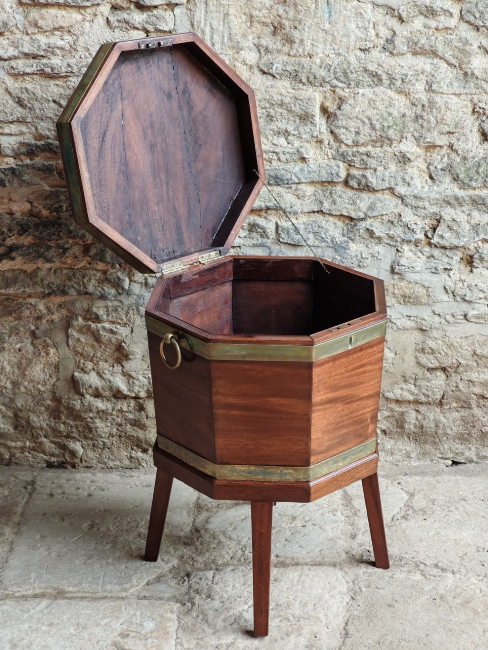 An 18th-century octagonal mahogany wine cooler with brass bindings, brass handles, and four tapered square legs. View IV