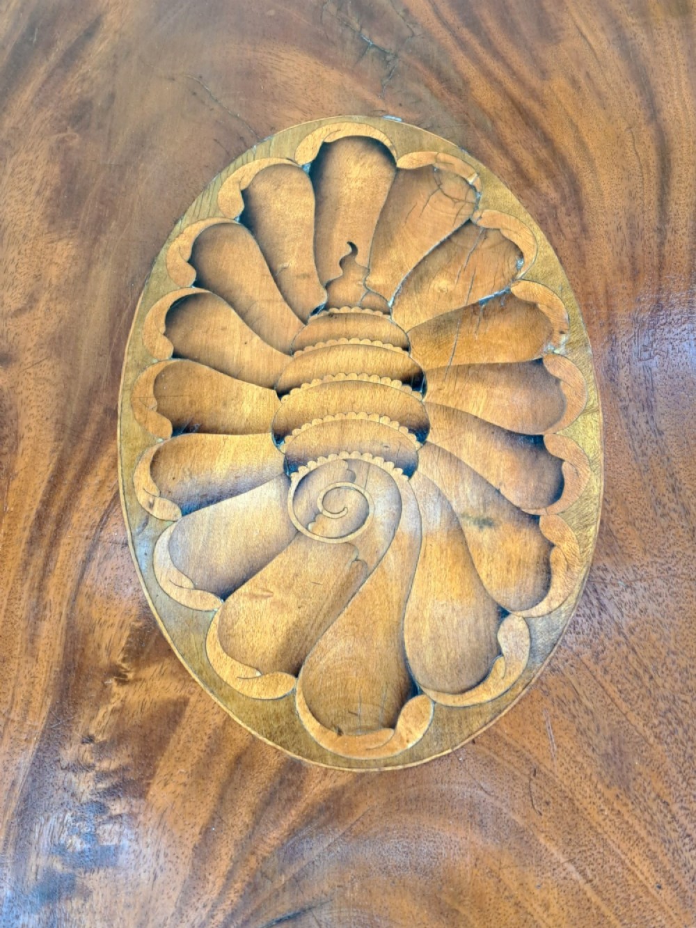 A George III mahogany drop-leaf Pembroke table featuring an oval satinwood shell inlay medallion, drawer with brass ring handles, and square tapered legs on brass castors. View VI