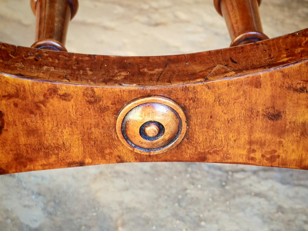 A mid-19th century X-frame stool crafted from figured burr maple, featuring a central turned stretcher and a neutral striped fabric upholstered seat. View IV