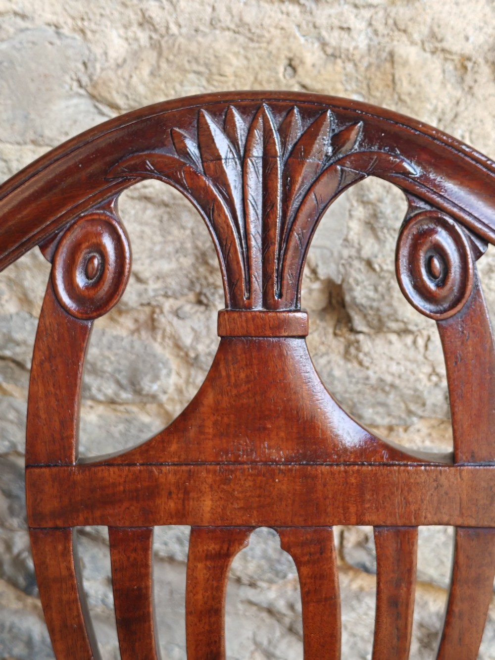 A set of six mahogany Hepplewhite dining chairs featuring carved shield backs with urn motifs and striped fabric upholstery. View VI