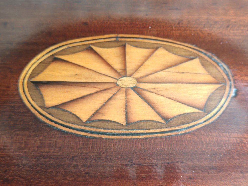 A Georgian mahogany dressing mirror featuring a shield-shaped swivel frame, bone finials, and an inlaid three-drawer box base. View VI