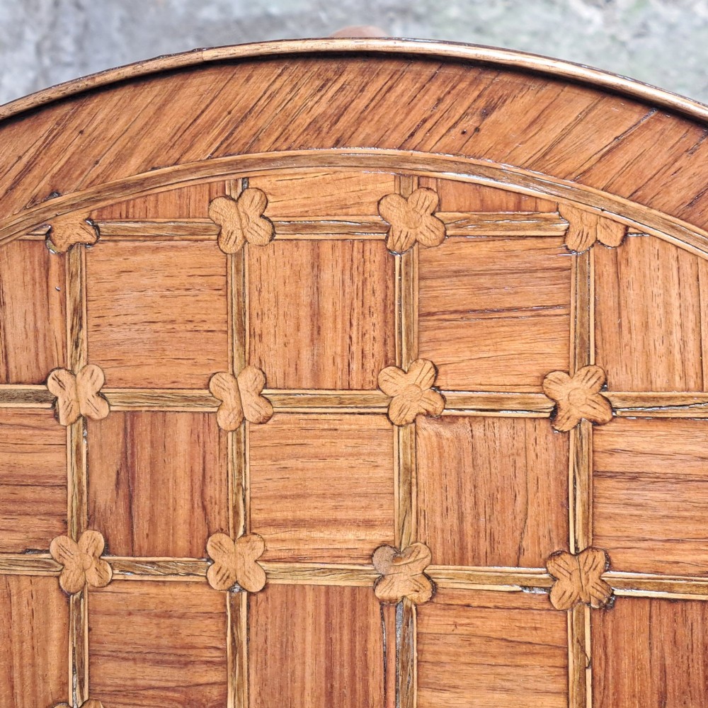 An antique circular French kingwood two-tier occasional table with geometric parquetry inlay, cabriole legs, and brass sabots. View IV