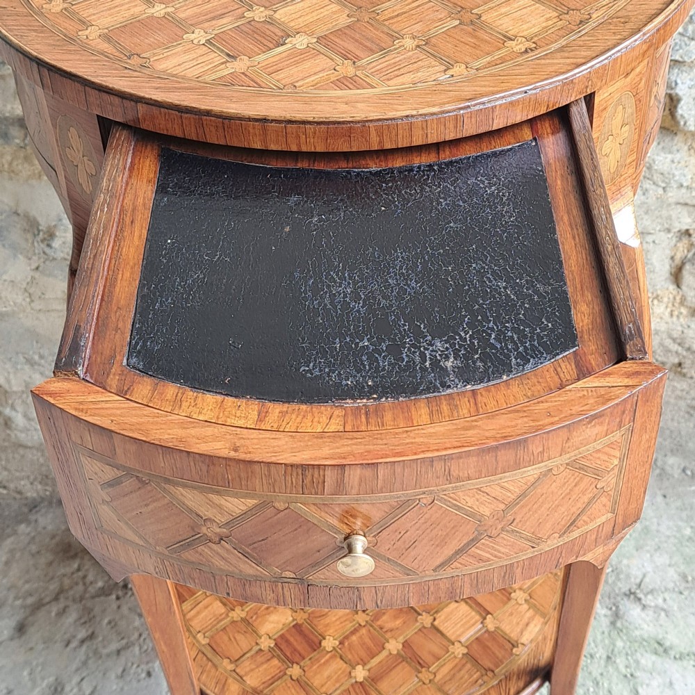 An antique circular French kingwood two-tier occasional table with geometric parquetry inlay, cabriole legs, and brass sabots. View VI