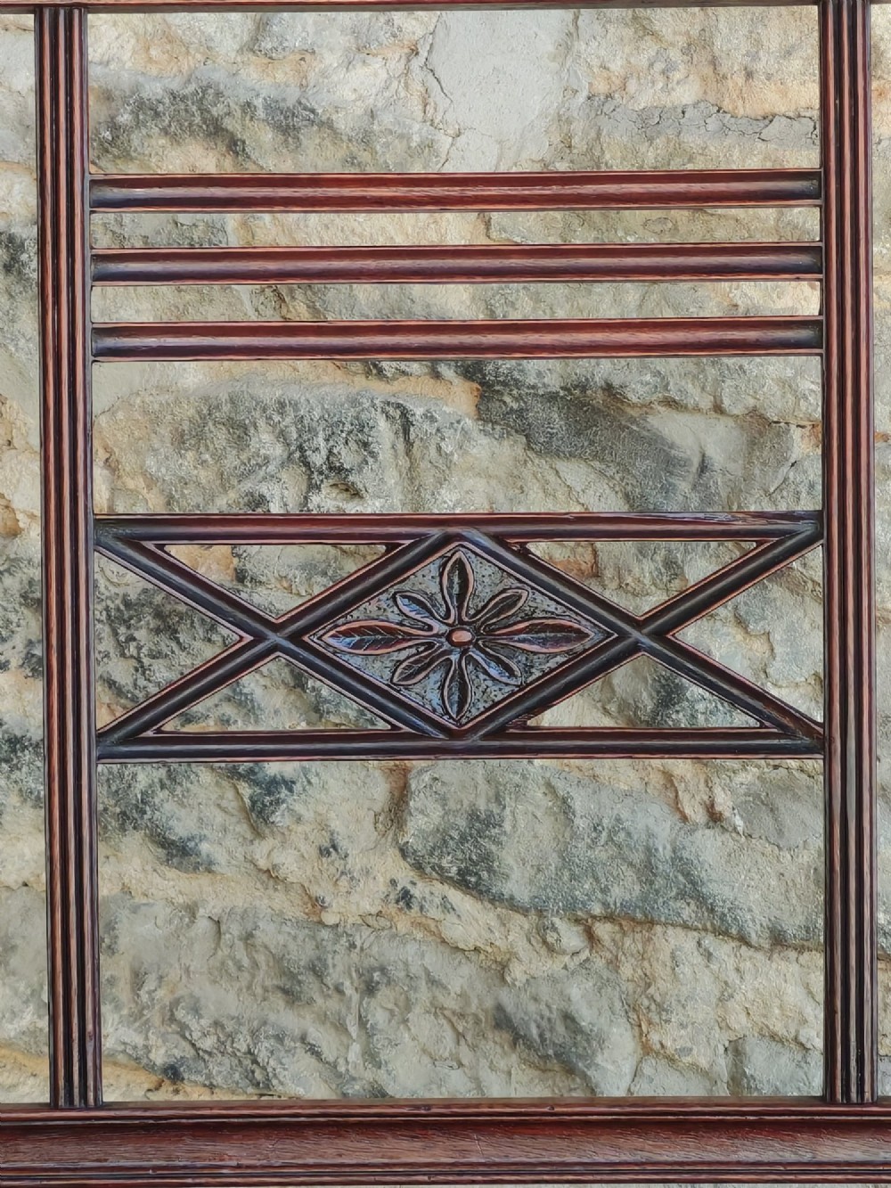 A late 18th-century Georgian mahogany carver chair featuring curved armrests, a carved diamond back splat, reeded front legs, and a red-striped upholstered seat. View VII