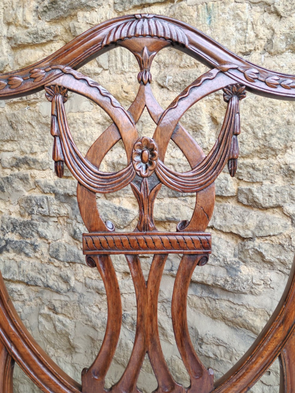 A Georgian walnut side chair featuring a carved shield backrest with openwork detailing and a patterned upholstered seat. View IV