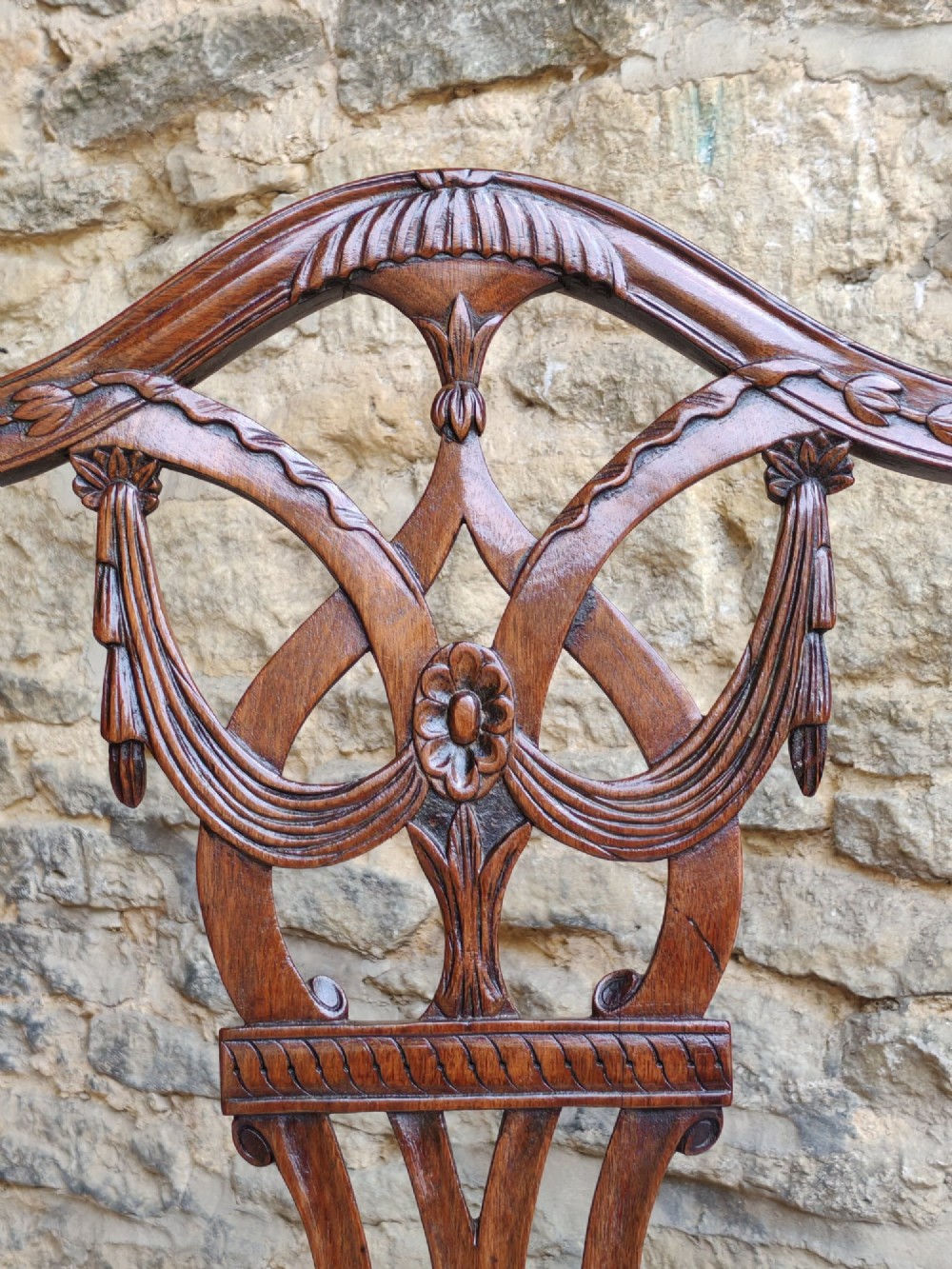 A Georgian walnut side chair featuring a carved shield backrest with openwork detailing and a patterned upholstered seat. View V