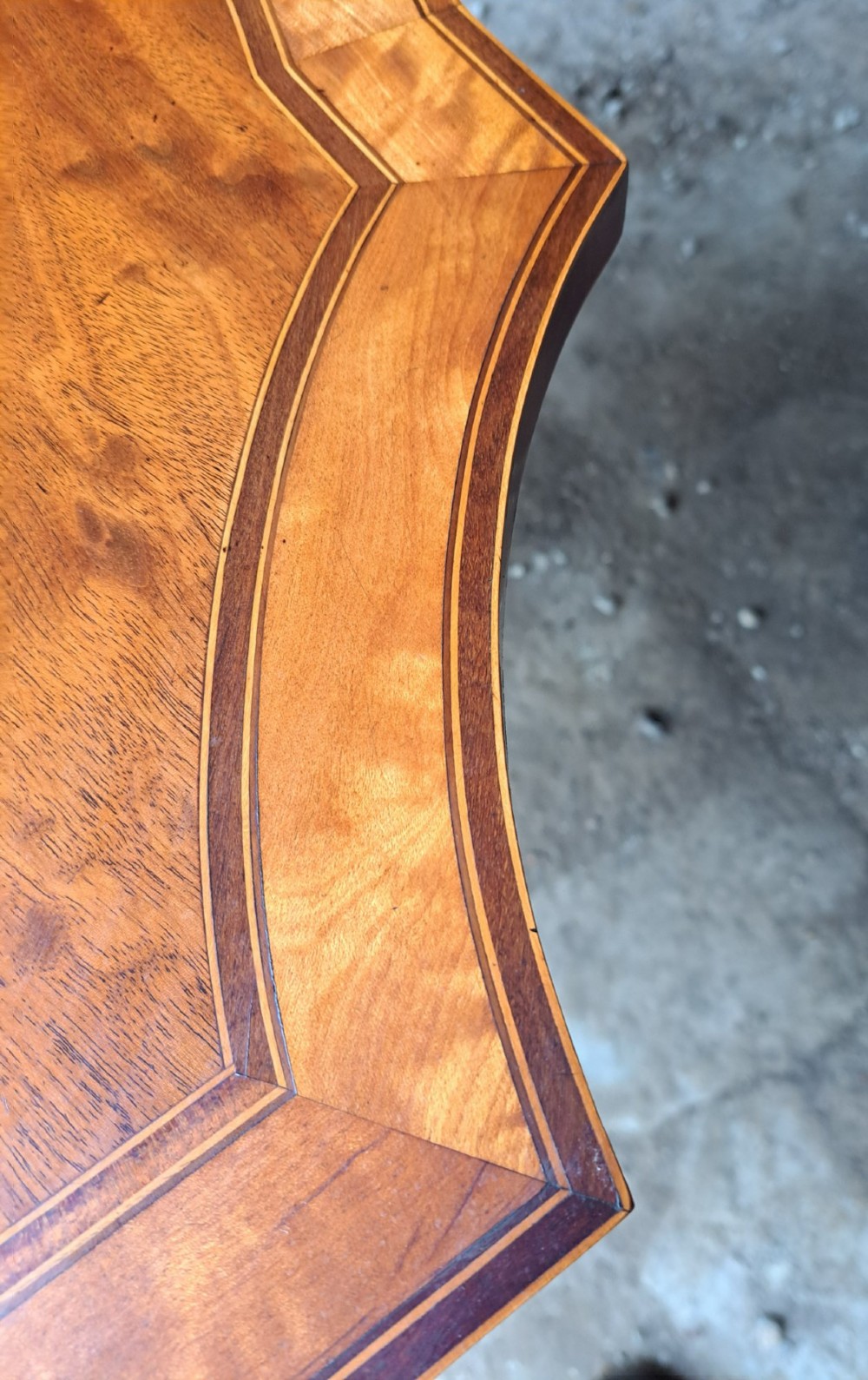 An antique late Victorian mahogany and satinwood fold-over tea table featuring a D-shaped top with satinwood crossbanding and tapered legs with floral marquetry. View IX