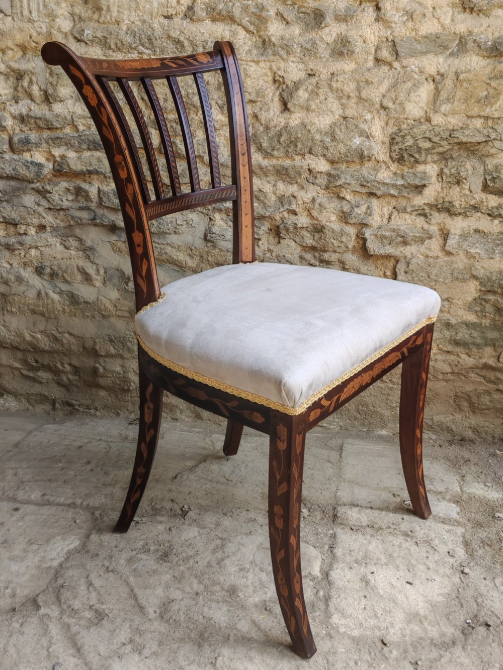 A pair of early 19th-century dark wood side chairs featuring floral marquetry inlay on the frames and light-coloured upholstered seats. View IV