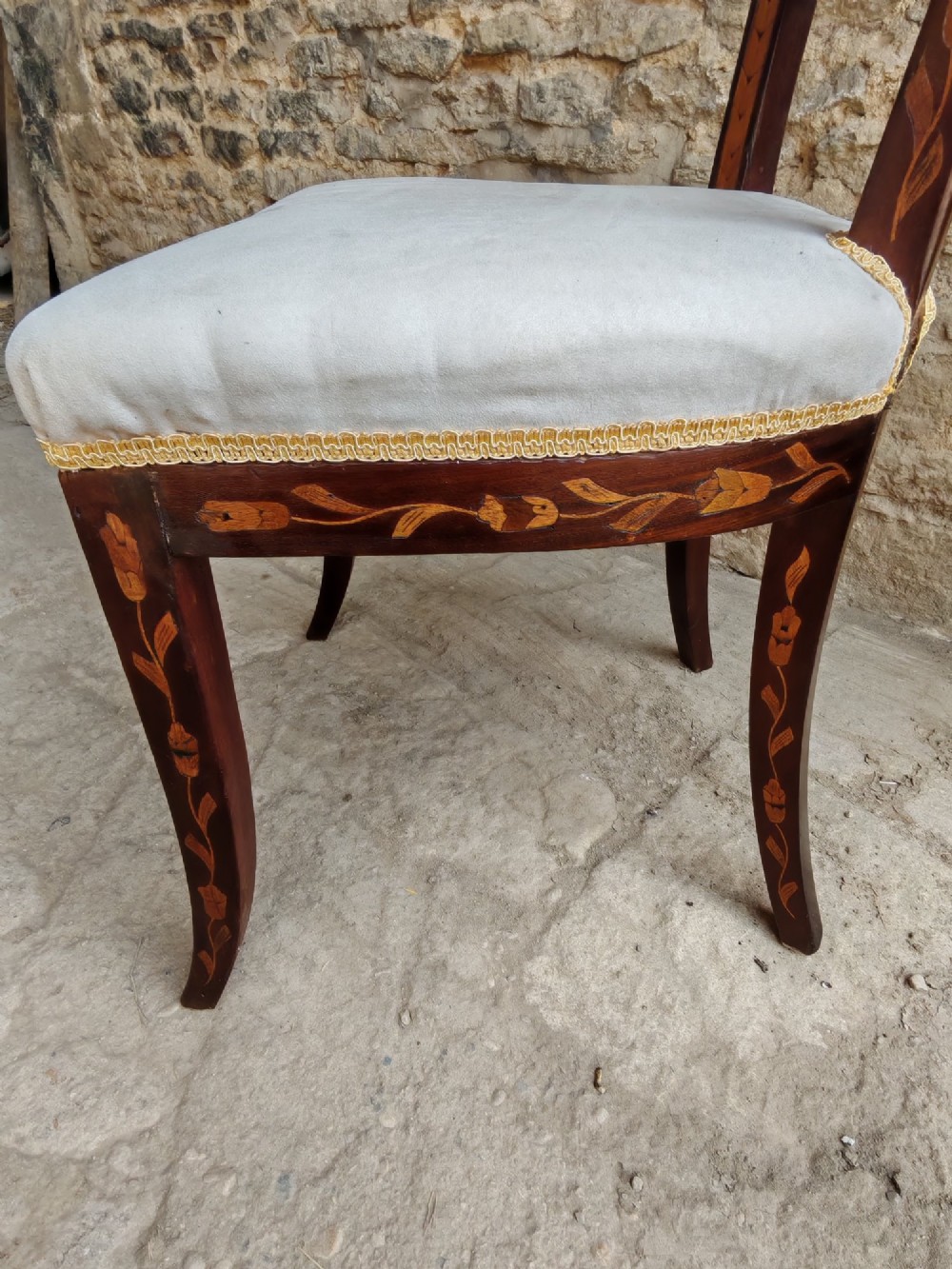 A pair of early 19th-century dark wood side chairs featuring floral marquetry inlay on the frames and light-coloured upholstered seats. View VII