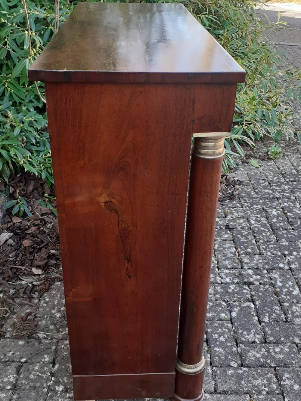 A low Regency rosewood bookcase featuring two glazed doors flanked by turned side columns with brass mounts. View II