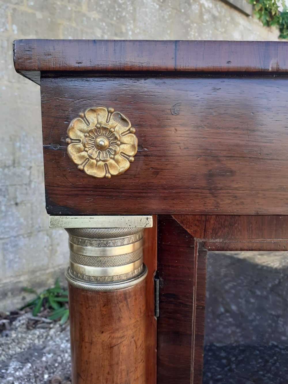 A low Regency rosewood bookcase featuring two glazed doors flanked by turned side columns with brass mounts. View IV