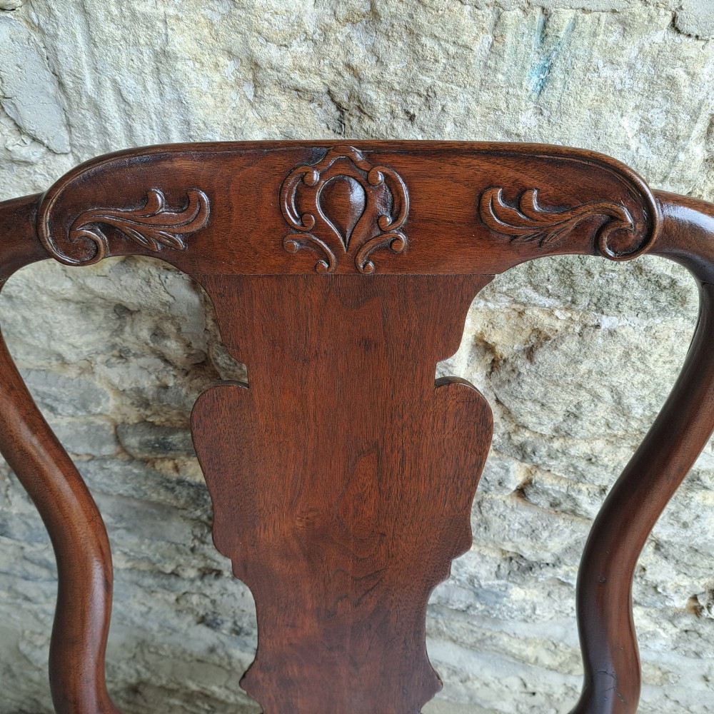 An 18th-century red walnut side chair with a shaped splat back, striped upholstered seat, and carved cabriole legs. View V