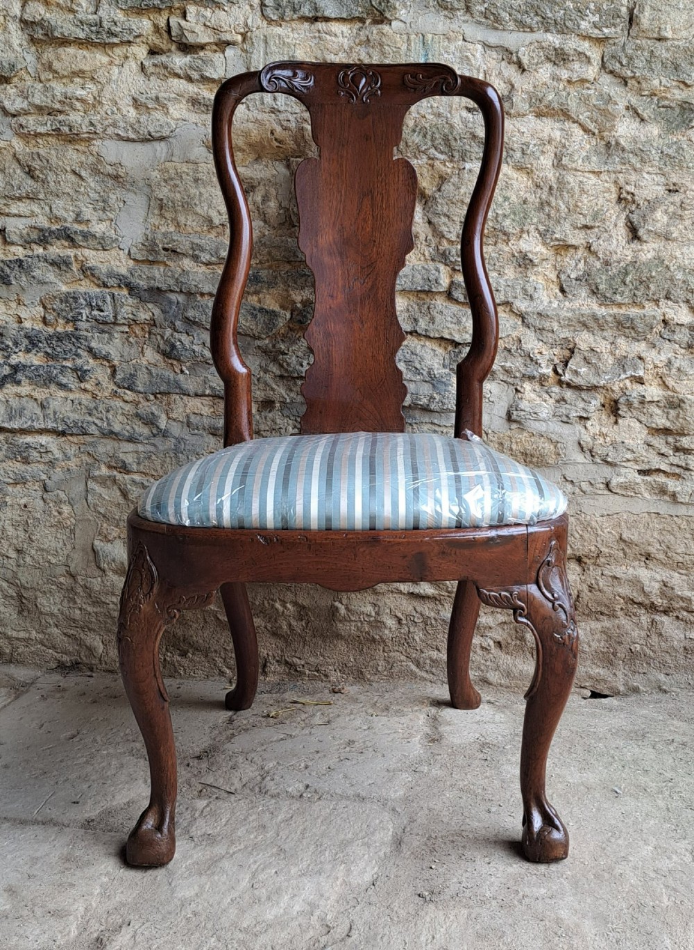 An 18th-century red walnut side chair with a shaped splat back, striped upholstered seat, and carved cabriole legs. View VIII