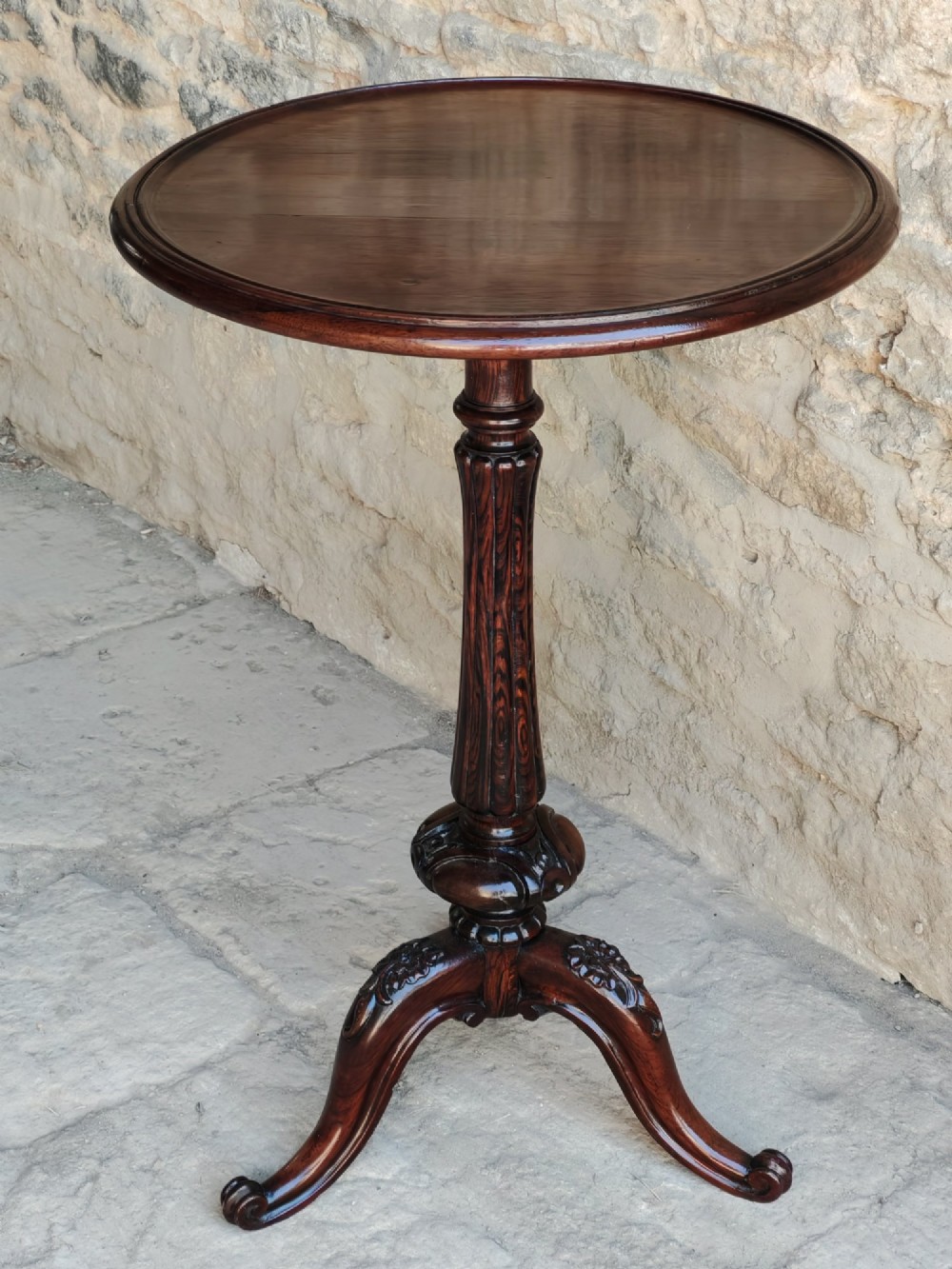 A circular dark rosewood Regency occasional table featuring a turned pedestal column and carved tripod legs. View II