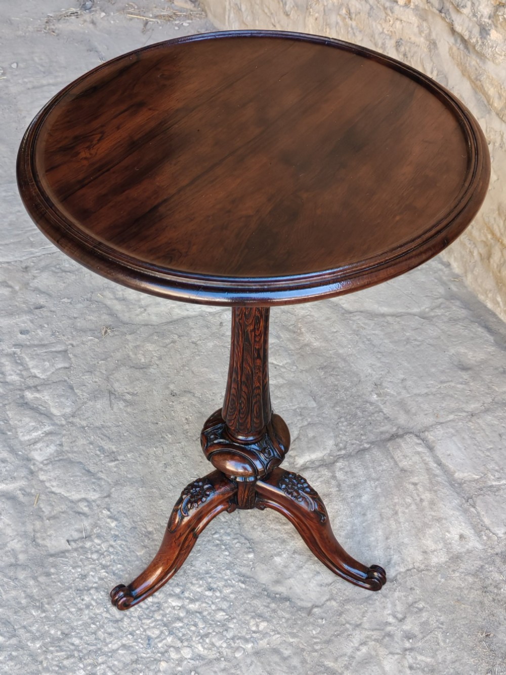 A circular dark rosewood Regency occasional table featuring a turned pedestal column and carved tripod legs. View III