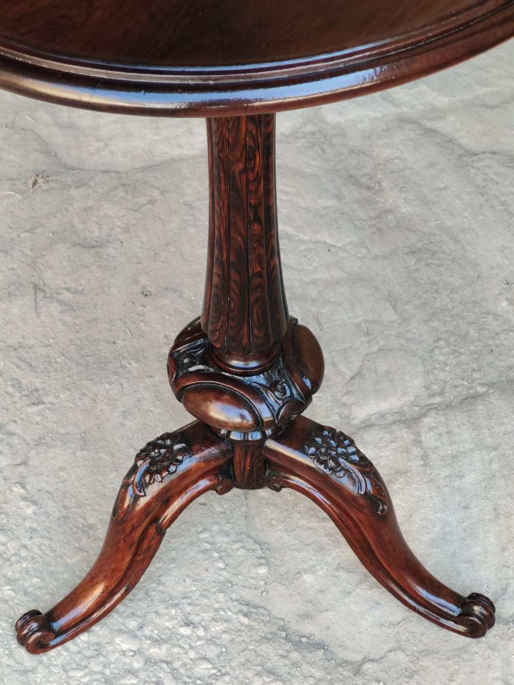A circular dark rosewood Regency occasional table featuring a turned pedestal column and carved tripod legs. View IV