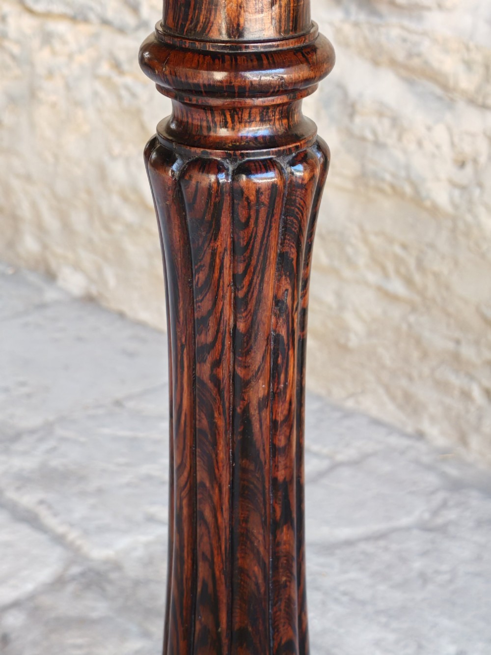 A circular dark rosewood Regency occasional table featuring a turned pedestal column and carved tripod legs. View V
