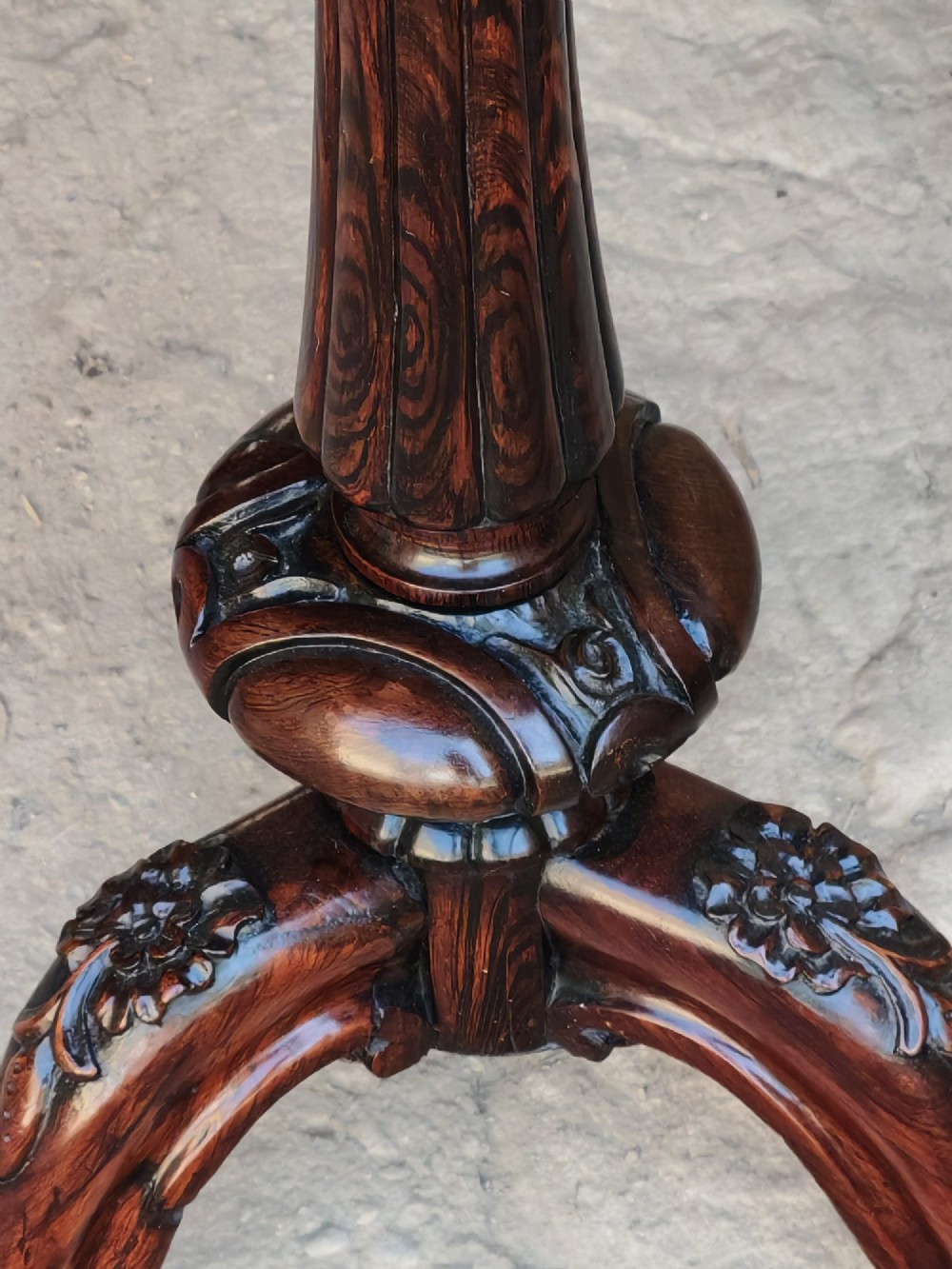A circular dark rosewood Regency occasional table featuring a turned pedestal column and carved tripod legs. View VI
