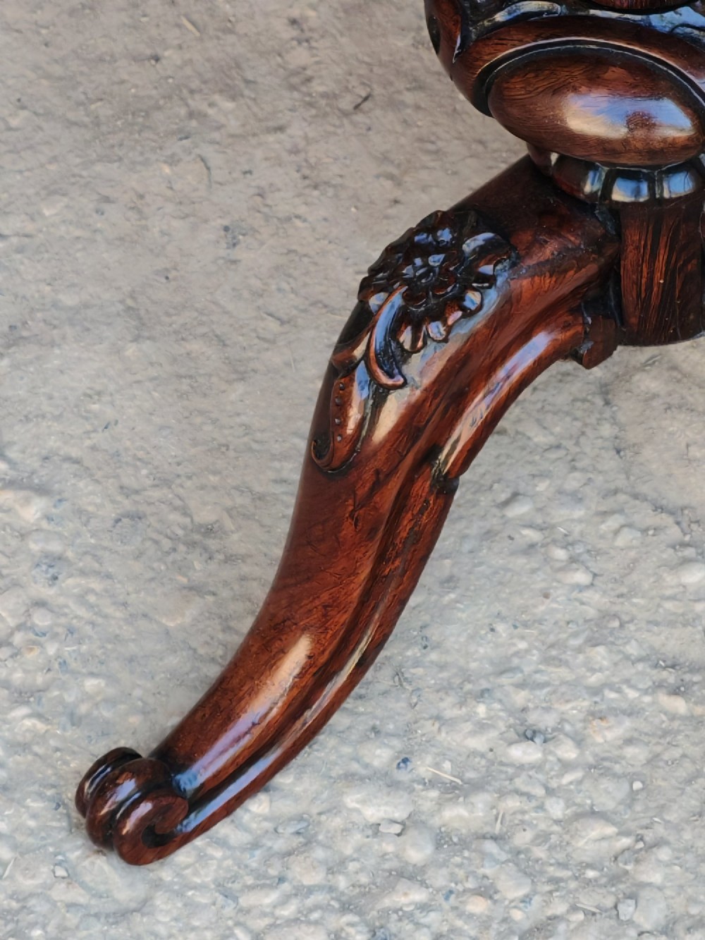 A circular dark rosewood Regency occasional table featuring a turned pedestal column and carved tripod legs. View VII