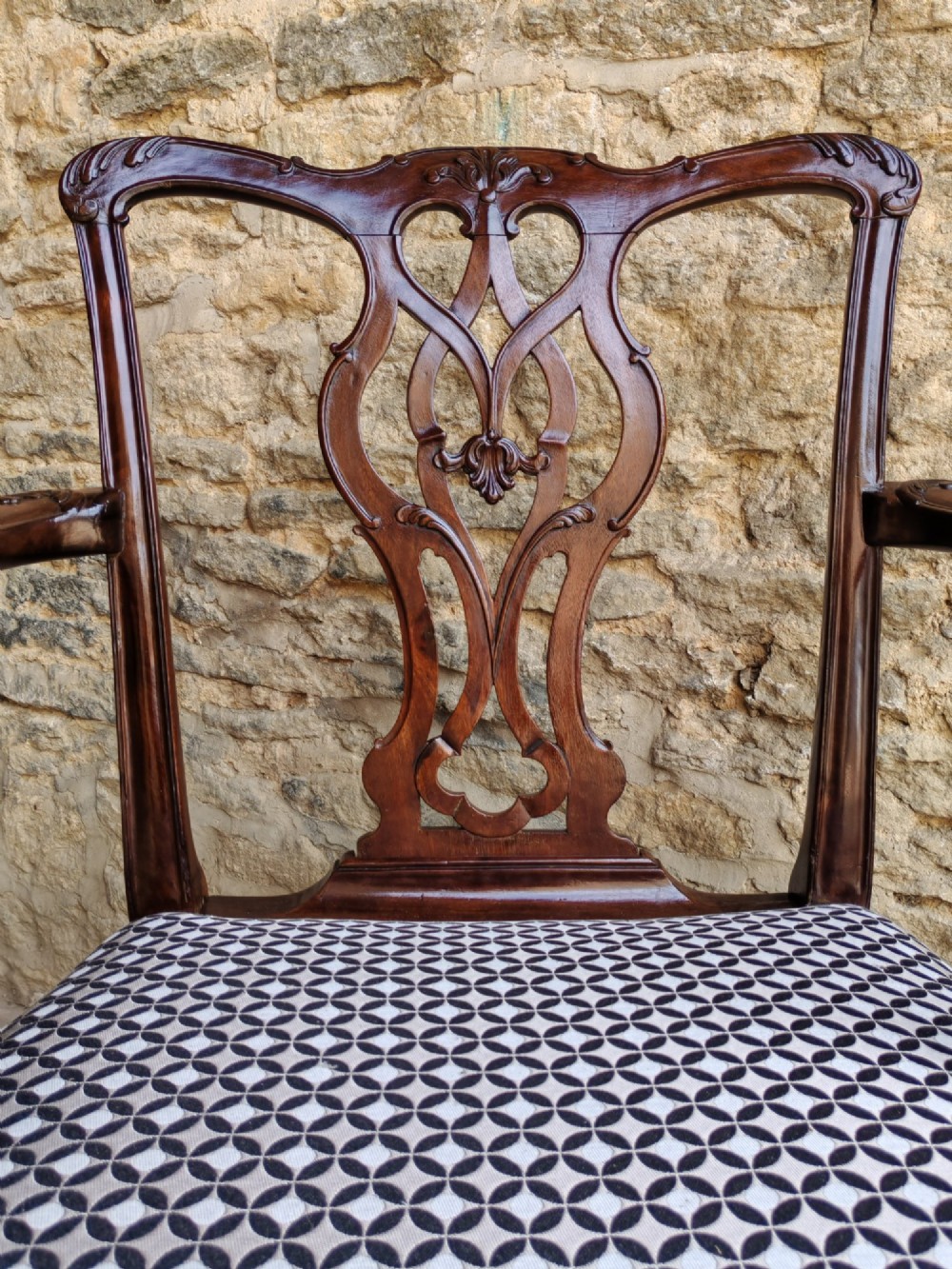 A Georgian mahogany carver armchair featuring a pierced back splat, shaped arms, square carved front legs, and geometric patterned fabric seating. View III