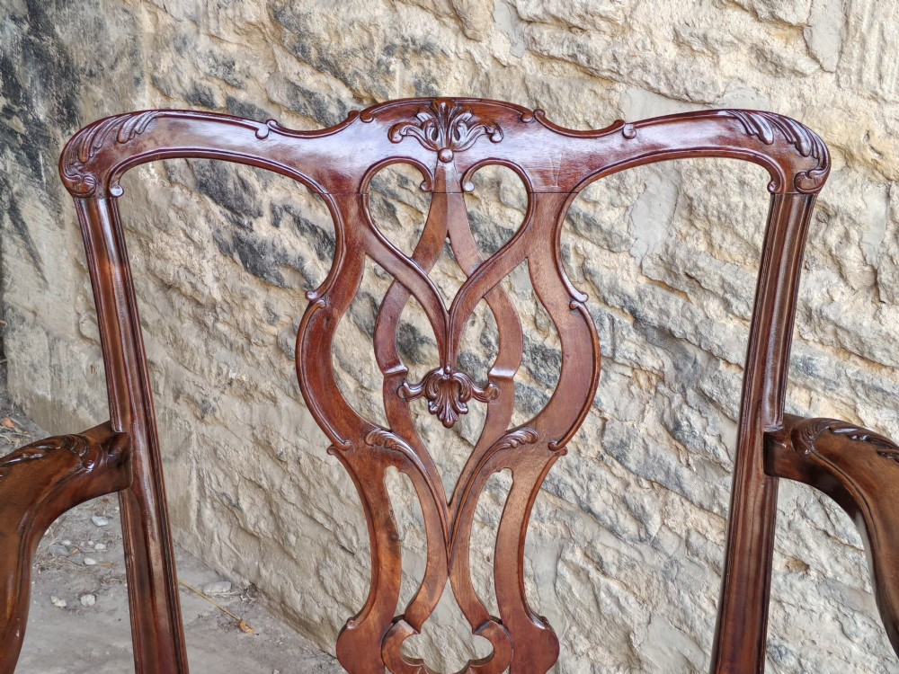 A Georgian mahogany carver armchair featuring a pierced back splat, shaped arms, square carved front legs, and geometric patterned fabric seating. View IV