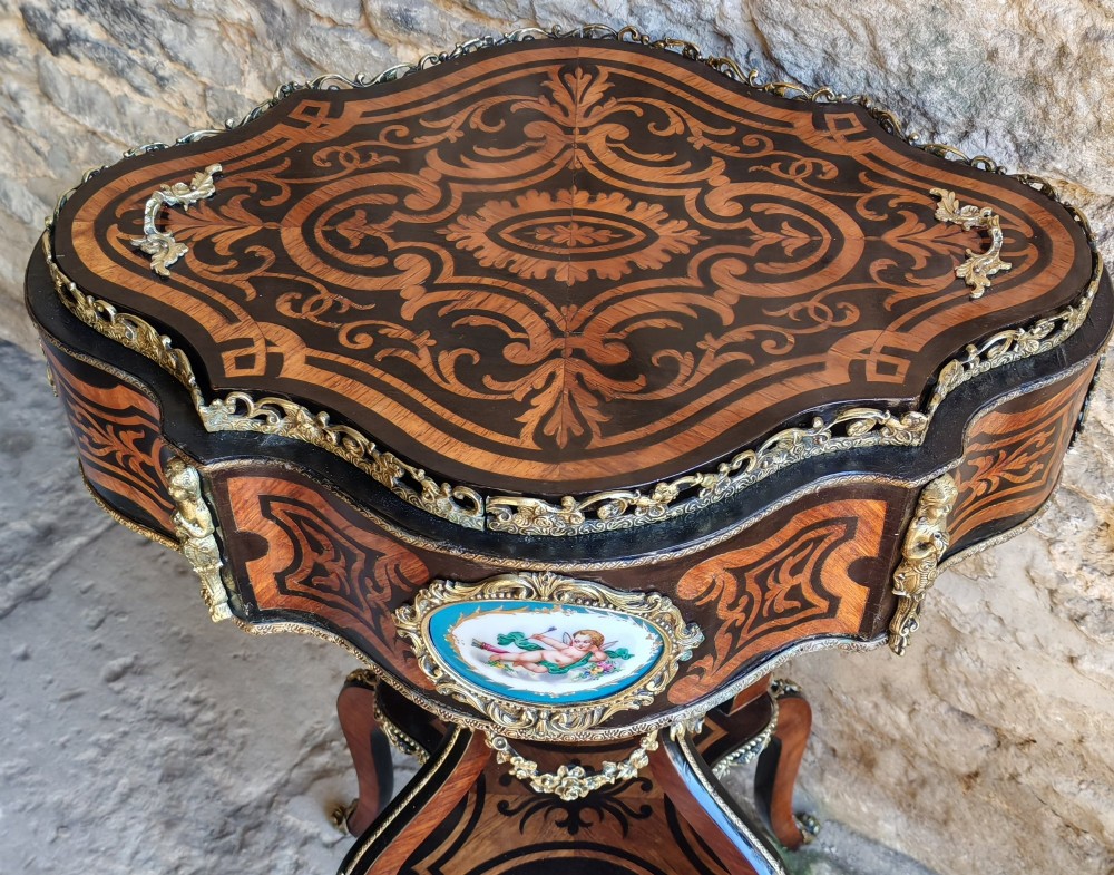 A 19th-century French marquetry jardiniere table with intricate wood inlay, ornate gilded mounts, a cherub porcelain plaque, and cabriole legs. View II