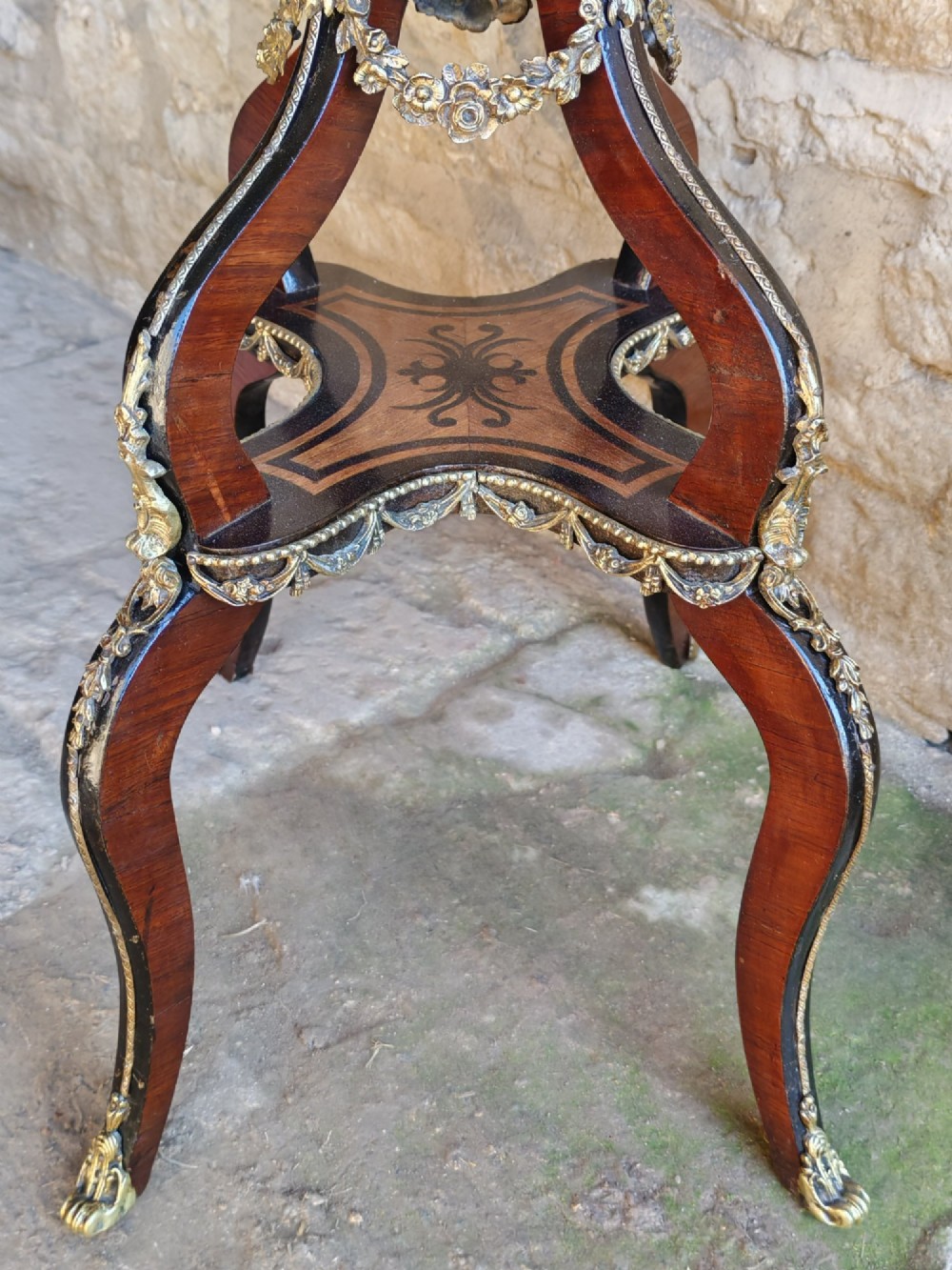 A 19th-century French marquetry jardiniere table with intricate wood inlay, ornate gilded mounts, a cherub porcelain plaque, and cabriole legs. View VI